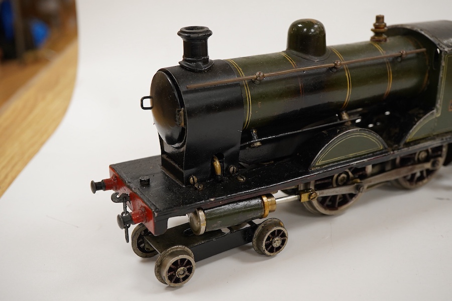 An 0 gauge live steam spirit fired tinplate GWR 4-4-0 tender locomotive, possibly Bing for Bassett-Lowke, 3411, with original fuel tank and burner, two controls in the cab and four wheel tender